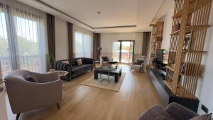 a living room with a couch and chairs and a table at Cunda EYE in Cunda