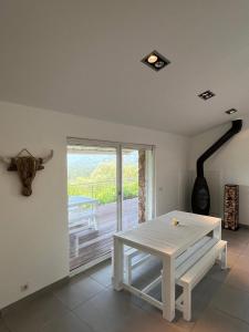 a white table in a room with a balcony at Torraccia in Porto-Vecchio +10 photos