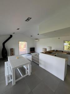 a living room with a table and a kitchen at Torraccia in Porto-Vecchio