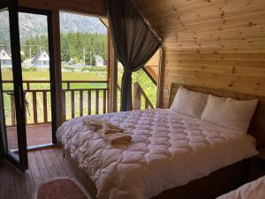 a bedroom with a bed in a log cabin at BUJTINA IZET SELIMAj in Valbonë +69 photos