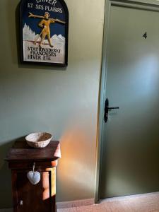 a sign on a wall next to a door with a table at Studio 4 Aux volets bleus in Aulus-les-Bains +1 photo