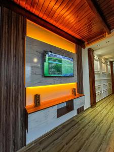 a living room with a large tv on a wall at Visit Chamal - Safran in Oued Laou +15 photos
