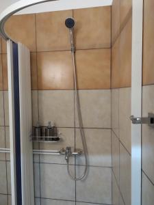 a shower with a shower head in a bathroom at Plaka - Acropolis comfort rooms in Athens +69 photos