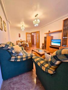 Una sala de estar con dos sofás y un televisor de pantalla plana. en Apartamento Las Olas Santa Pola, en Santa Pola