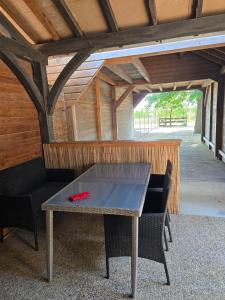 una mesa de ping pong en un pabellón con un banco en Etape cocooning, en Villefranche-Saint-Phal