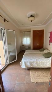 Ένα ή περισσότερα κρεβάτια σε δωμάτιο στο Algarrobo Room, your corner of calm and magical views
