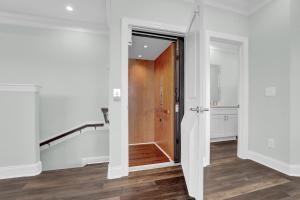 an open hallway with a wooden door and stairs at 6 Bedrooms, New Construction, Ocean and Sound Views in North Topsail Beach
