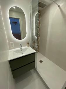 a bathroom with a sink and a mirror at Appartement pieds dans l eau vue mer in Concarneau +29 photos