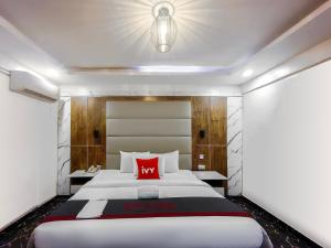En eller flere senger på et rom på Ivy Hotel Awolowo