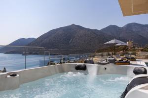 a hot tub with a view of the mountains at Celeste Bali Suites in Balíon