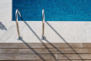 a pair of metal rails next to a swimming pool at Feel Discovery Casa do Alfaiate in Peso da Régua +20 photos