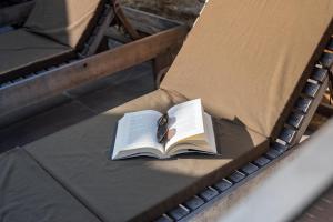 a book and pair of glasses sitting on a bench at Feel Discovery Casa do Alfaiate in Peso da Régua