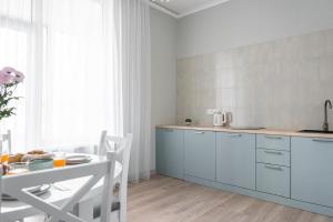 a kitchen with a table and a white counter top at Aqzam in Zhezdi +2 photos