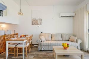 a living room with a couch and a table at GW212 Gugel Waves Amazing Seaview Pool Apartments in Nahariyya