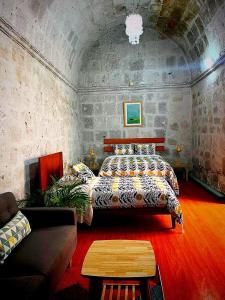 un dormitorio con una cama y un sofá en Bubamara San Lazaro, en Arequipa