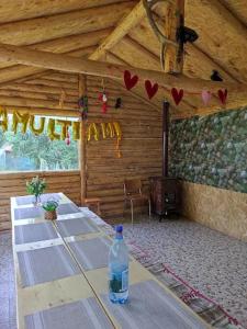 a bottle of water sitting on a table in a room at Vila Rodica in Lunca Mare