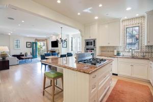 een keuken met witte kasten en een aanrechtblad bij Casa Cielo in Santa Barbara