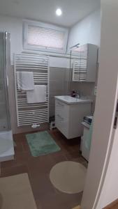 a small bathroom with a sink and a window at Uta Arneke in Bodenwerder