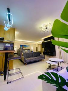 a living room with a couch and a table at Cozy Studio near Airport in Pusok