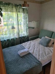a small bedroom with a bed and a window at Fjällnära Villa i Vidsel in Vidsel +12 photos