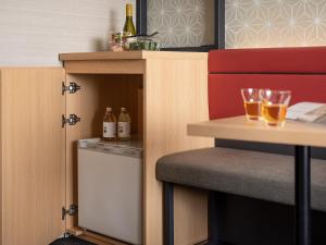 a small kitchen with a table and a dishwasher at Mitsui Garden Hotel Kyoto Shijo in Kyoto
