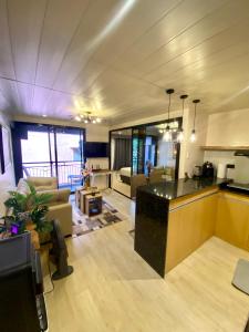 a large room with a kitchen and a living room at Cozy Studio near Airport in Pusok +20 photos