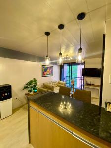 a kitchen and living room with a large counter top at Cozy Studio near Airport in Pusok