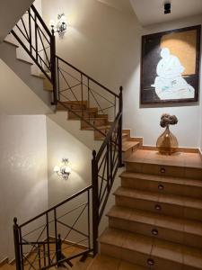 eine Treppe in einem Haus mit einem Gemälde an der Wand in der Unterkunft Hotel Bouza in Ribadeo