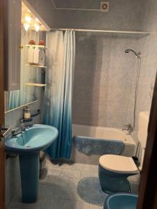a bathroom with a blue sink and a toilet and a tub at Beautiful 3-Bed House in Tavira In the city center in Tavira +31 photos