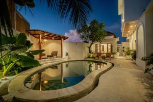 a swimming pool in the middle of a house at Hastana Villa in Sukawati