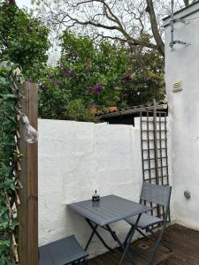 a picnic table and chairs on a patio at Cottage, private terrace in La Rochelle in La Rochelle