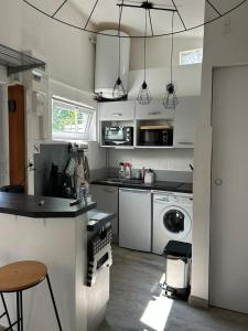 a kitchen with a sink and a dishwasher at Cottage, private terrace in La Rochelle in La Rochelle