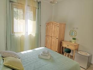 a bedroom with a bed and a dresser and a window at Le tre civette in Agropoli