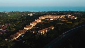 an aerial view of a large house with the ocean at The Edwardian in Port Edward