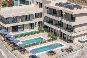 an aerial view of an apartment building with two swimming pools at Celeste Bali Suites in Bali