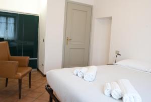 a hotel room with a bed and a chair at Villa Pini Balbiani - Appartamento Pini in Lierna +45 photos