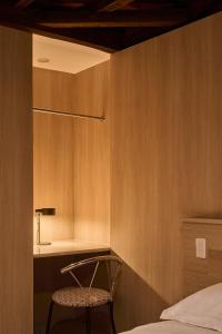 a bedroom with a bed and a chair in it at Alchemy 0 in Osaka +19 photos