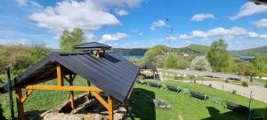 a small playground with a roof on the grass at La Merveille 795-848-628 in Solina