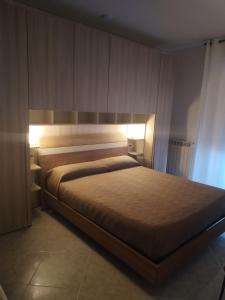 a bedroom with a large bed with lights on it at RIU b&b ALGHERO in Alghero