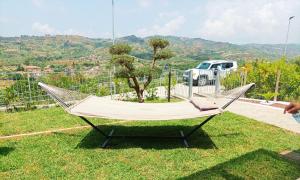 a hammock in the grass with a truck in the background at villa vener le terrazze degli dei in Marina di Ascea +39 photos