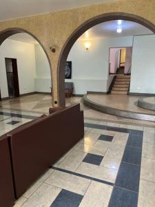 a lobby with an archway and a staircase in a building at Starehe Villa in Arusha
