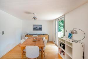 a dining room with a wooden table and chairs at Villa Piscine Entre Lac et Océan in Soorts-Hossegor