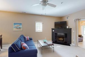 a living room with a blue couch and a fireplace at Summerlyn --- 34297 Summerlyn Dr, Apt 501 in Lewes