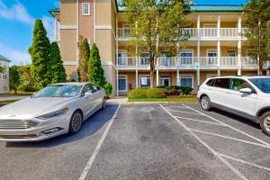 two cars parked in a parking lot in front of a building at Summerlyn --- 34297 Summerlyn Dr, Apt 501 in Lewes