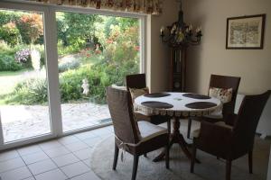 a dining room with a table and chairs and a window at Peace-Deluxe**** in Bingen am Rhein
