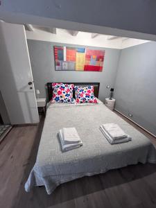a bedroom with a bed with towels on it at La Stanza dei Citti-Martino in Arezzo