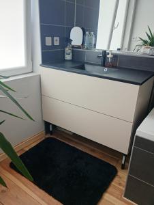 a kitchen counter with a sink and a black rug at Mi casa es tu casa in Orchies +9 photos