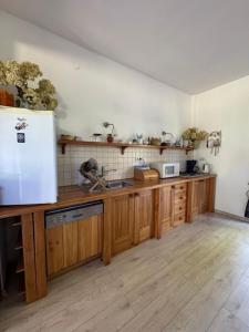 a kitchen with wooden cabinets and a white refrigerator at Istebna715 in Istebna