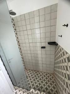 a bathroom with a shower with a tiled floor at Apartment del centro in Santa Rosa