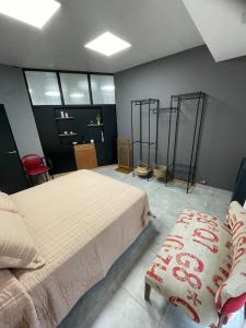 a bedroom with a large bed and a chair at Apartment del centro in Santa Rosa